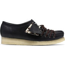 Load image into Gallery viewer, A black leather low-top shoe with dark brown laces, a patterned fabric accent tab, and a thick beige sole, shown in a side profile on a white background.
