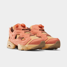 Load image into Gallery viewer, A pair of retro-style platform sneakers in a peachy coral and beige colorway, featuring a chunky sole and circular side details, photographed on a light gray background.