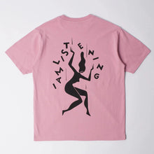 Load image into Gallery viewer, A pink short-sleeve t-shirt shown from the back, featuring a black graphic of a dancing woman surrounded by the text 'I AM LISTENING'.