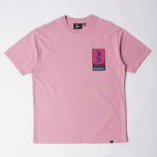 Load image into Gallery viewer, A light pink short-sleeve crewneck t-shirt with a small rectangular graphic on the left chest featuring a stylized figure and the brand name 'PARKA'.