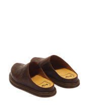 Load image into Gallery viewer, A pair of dark brown leather slip-on shoes with embossed western-style floral patterns, shown from a three-quarters rear angle on a white background.