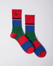 Load image into Gallery viewer, A pair of crew socks with bold horizontal color-blocked stripes in red, green, blue, and pink, featuring a black embroidered logo on the cuff, displayed on a light gray background.