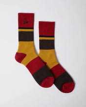 Load image into Gallery viewer, A pair of crew socks with horizontal stripes in red, mustard yellow, and dark brown, featuring a black embroidered logo on the cuff, displayed on a light gray background.